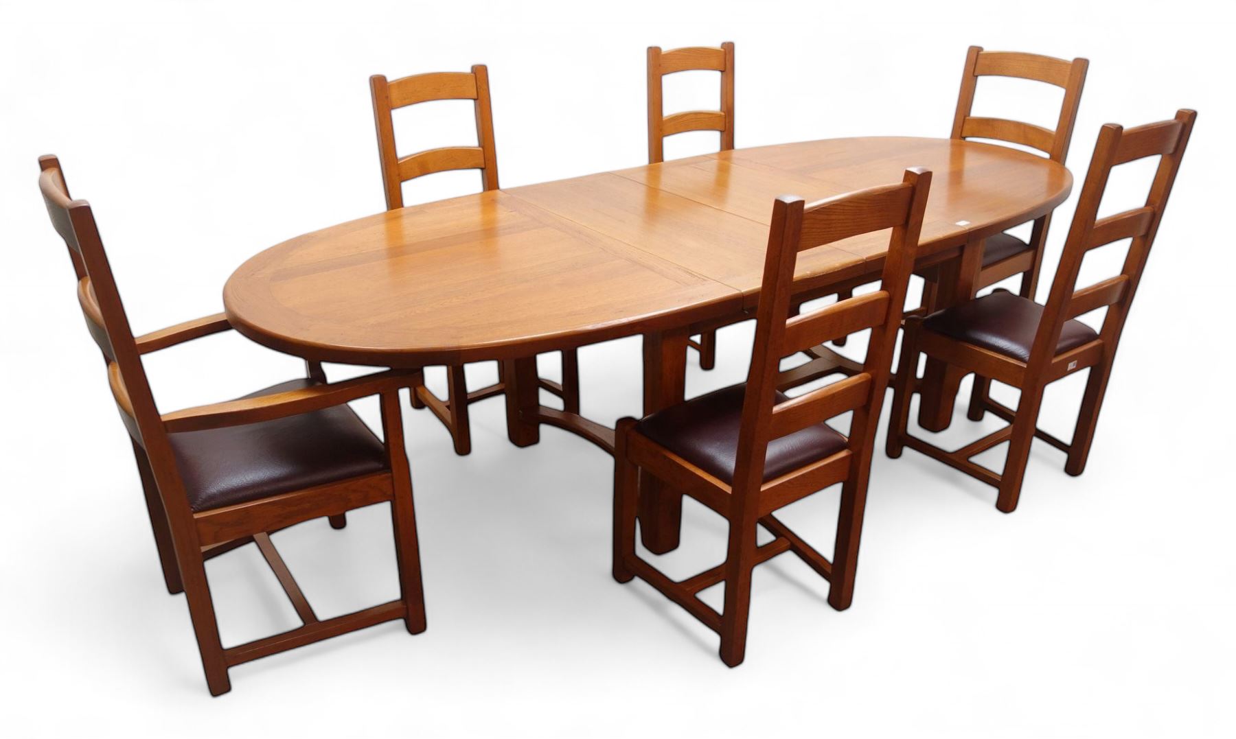 French solid oak oval extending dining table with two leaves, square supports joined by curved 'H' stretcher; set of six (4+2) ladder back chairs with upholstered seats (W59cm)