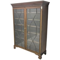 19th century mahogany bookcase, stepped moulded cornice over two astragal glazed doors, with five adjustable shelves, bone oval escutcheons, on bracket feet