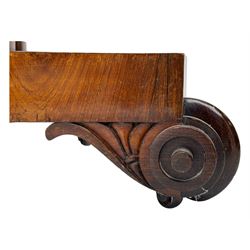 Early Victorian rosewood card table, rectangular foldover swivel top with rounded corners, red baize-lined surface, frieze adorned with carved foliate motifs, supported by a central octagonal waisted column on shaped quatrefoil base, terminating in scrolled feet with concealed metal castors