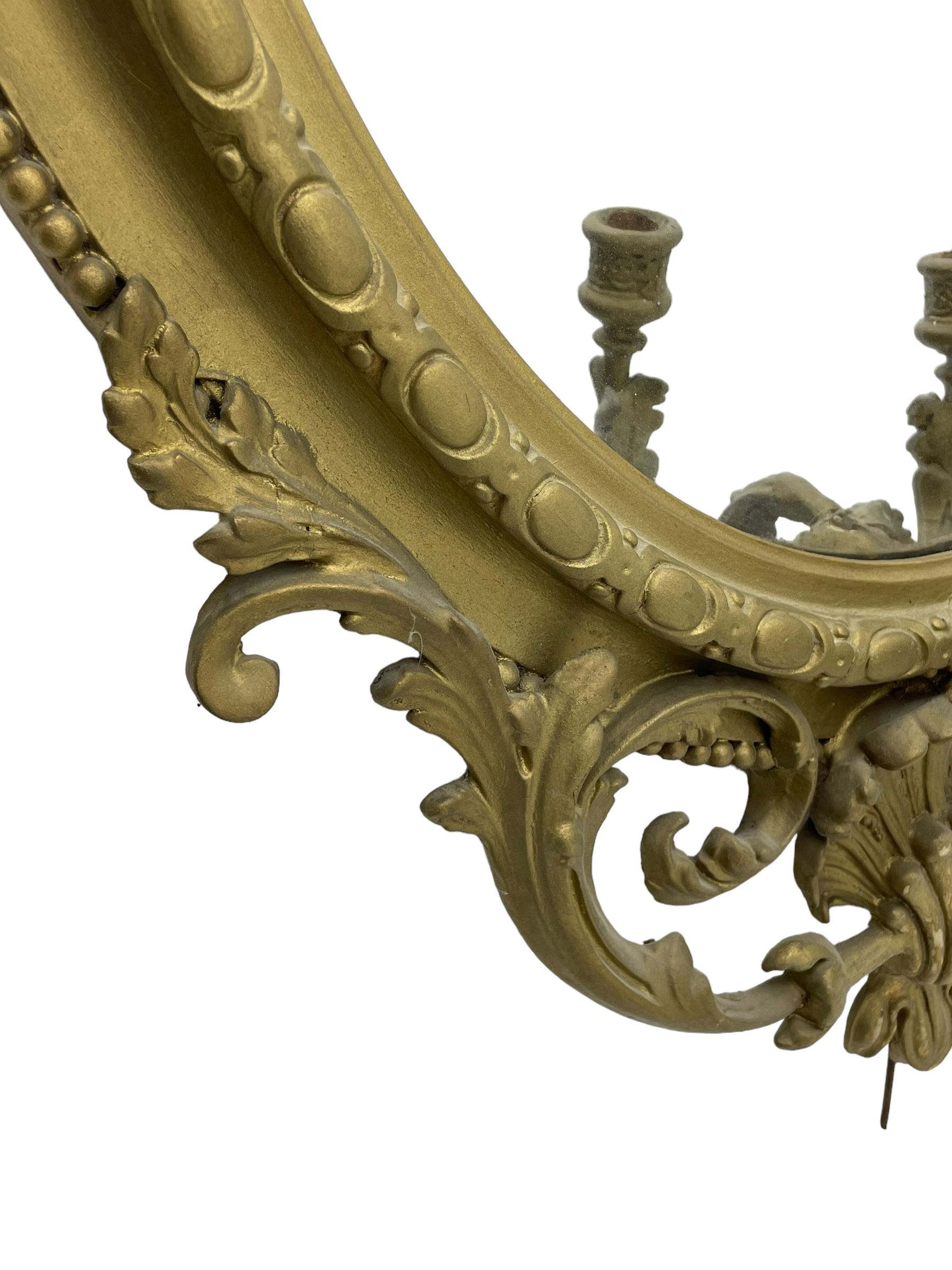 19th century giltwood and gesso girandole wall mirror, the raised pediment decorated with ribbon tie over curled acanthus leaves and flowerhead festoons, oval egg and dart moulded frame with outer bead, three projecting candle sconces in the form of scrolled acanthus leaves, lower shell motif with extending leaf decoration 