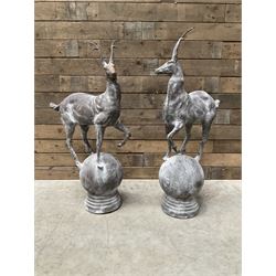 Pair of cast iron garden Stag figures or gate finials, raised on spherical ribbed base 