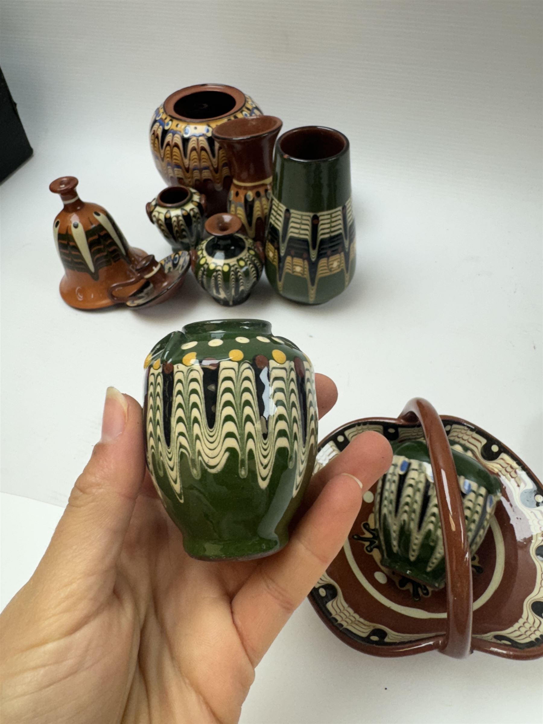 Collection of slipware, including miniature vases, baskets, candlesticks jugs etc 