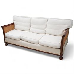 Early 20th century mahogany framed bergère three seat sofa, upholstered back and seat flan...