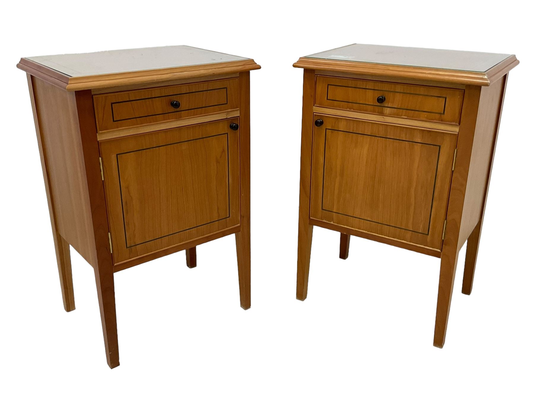 Pair of contemporary cherry wood bedside cupboards, inset glass top in moulded frame, fitted with single drawer over cupboard, on square tapering supports 