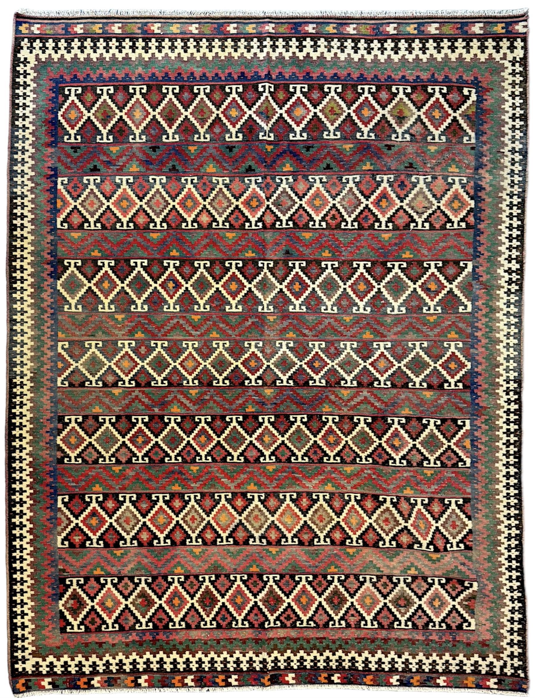 Northeast Persian Sumak Kilim red ground rug, the field decorated with rows of multicoloured diamond motifs featuring  geometric patterns, the border composed of alternating black and white stepped designs, enclosed by a narrow band with multicoloured geometric shapes