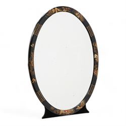 Edwardian chinoiserie decorated easel mirror, oval black lacquered and raised gilt work frame depicting figures within natural landscapes and wildlife, bevelled mirror plate, brass hinge on fabric lined back and shaped support  