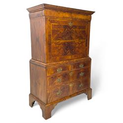 Early 18th century William & Mary figured walnut escritoire, projecting moulded cornice over shallow frieze drawer, the figured fall front enclosing interior fitted with small drawers, cupboards, pigeon holes and hidden drawers, the lower section fitted with two short and two long graduating drawers, on tall bracket feet 