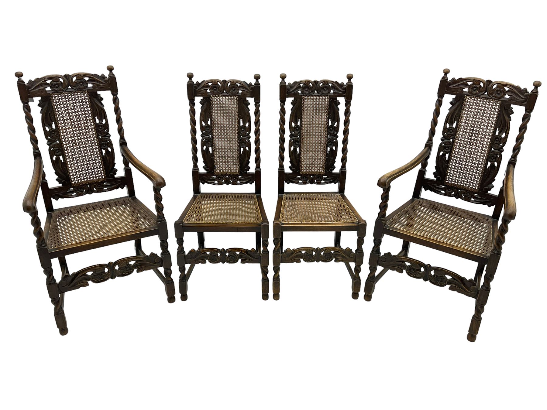 Set of seven (5+2) 19th century Carolean design oak dining chairs, scroll leaf and flower head carved cresting rail over spiral turned uprights and cane work back, the cane work seat on spiral turned supports united by plain stretchers, scrolled leaf carved middle rail 