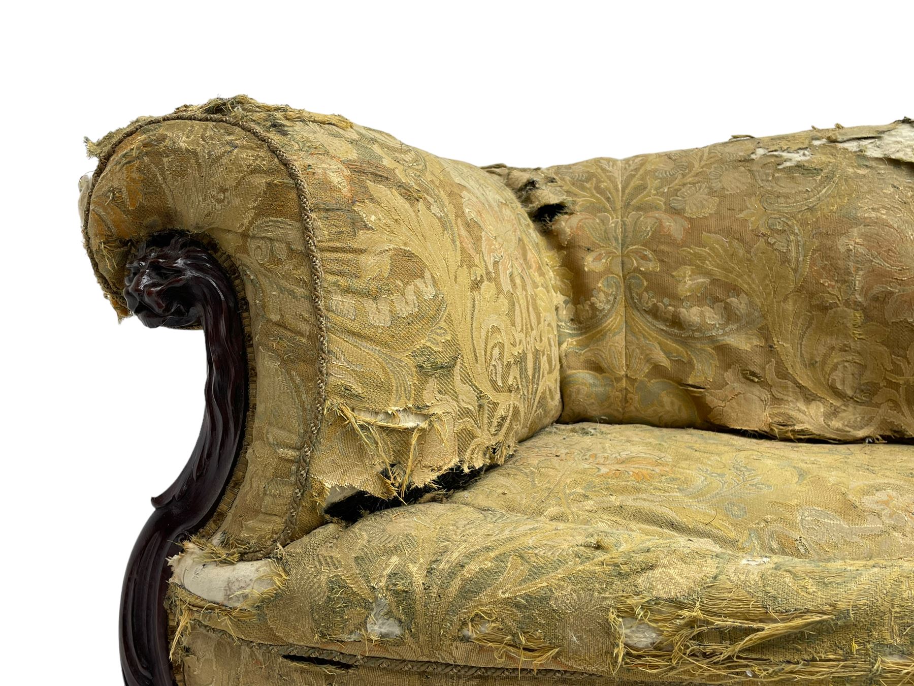 19th century mahogany settee, rolled S-scrolled arms carved with lion masks and acanthus leaf scrolls, the lower moulded rail carved with scrolling design, raised on carved paw feet with recessed brass and ceramic castors 