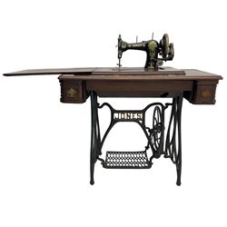 Early 20th century Jones treadle sewing machine table, bevel edged rectangular top with hinged lid enclosing sewing machine no. 480760, supported by cast iron treadle base