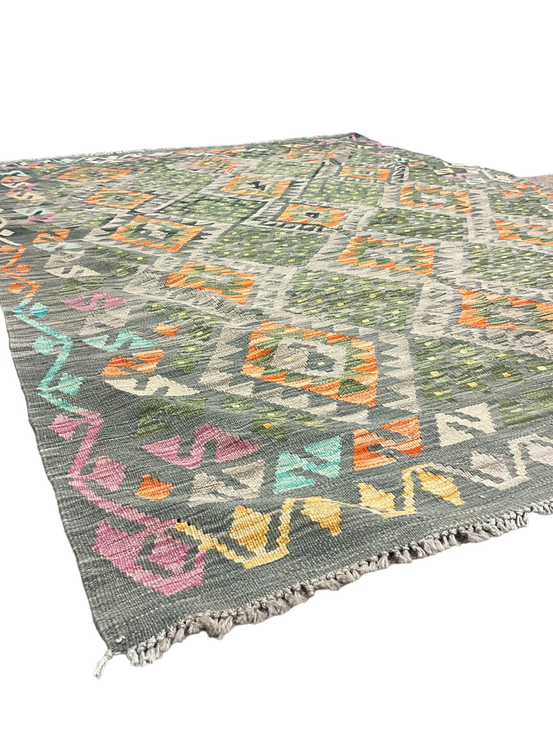 Kilim grey and green ground rug, overall geometric design decorated with lozenges