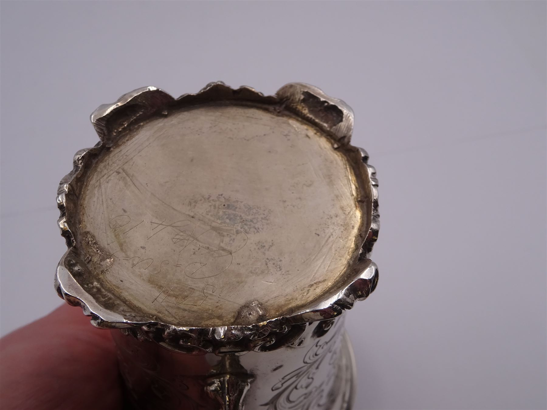 Victorian silver christening mug, of cylindrical form with fluted rim, gilt interior and acanthus capped C scroll handle, the body with later engraved decoration and initials, with embossed scroll base, hallmarked John Evans II, London 1840, including handle H10.2cm