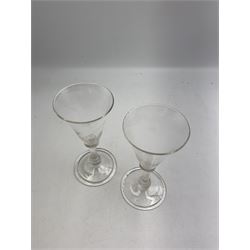 Pair of 18th century Liege wine glasses, circa 1730, with wrythen fluted trumpet bowls and knopped stems, H14.5cm