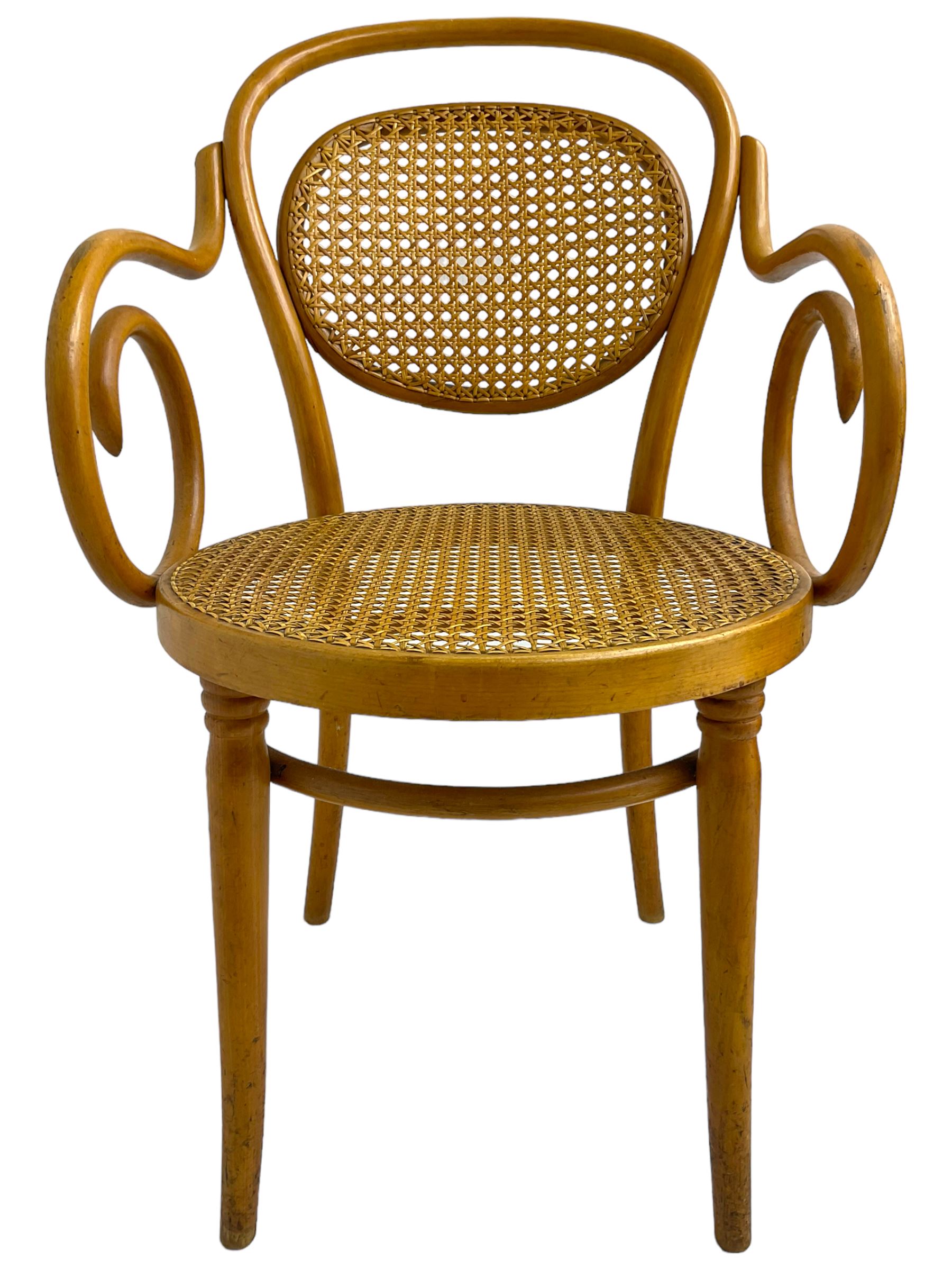 After Michael Thonet - bentwood armchair, circular cane seat and back, scrolled arms