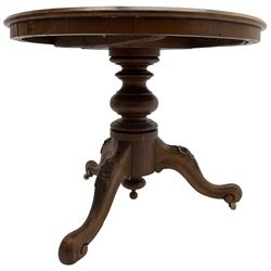 Victorian mahogany centre table, circular top on turned pedestal, on three flower head carved supports with scrolled terminals