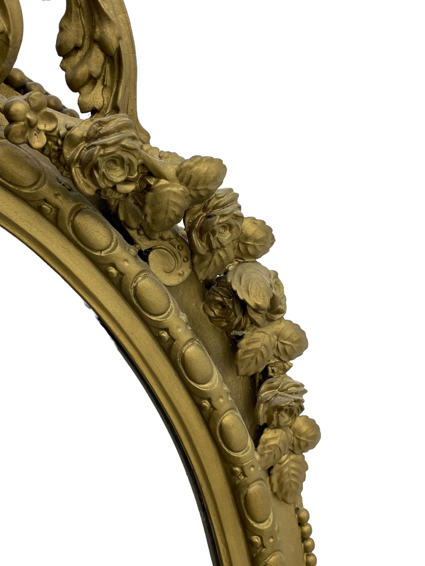 19th century giltwood and gesso girandole wall mirror, the raised pediment decorated with ribbon tie over curled acanthus leaves and flowerhead festoons, oval egg and dart moulded frame with outer bead, three projecting candle sconces in the form of scrolled acanthus leaves, lower shell motif with extending leaf decoration 