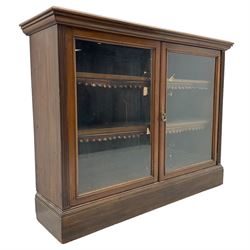 Phillips & Sons Ltd Bristol - Victorian mahogany glazed bookcase, projecting moulded cornice over two glazed doors, enclosing two shelves with scalloped edging, raised on a plinth base