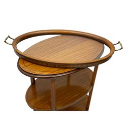 Edwardian satinwood tray top stand of oval form, tray top with glazed base and brass handles over two tiers, each with checkered inlaid band, on square tapering and splayed supports