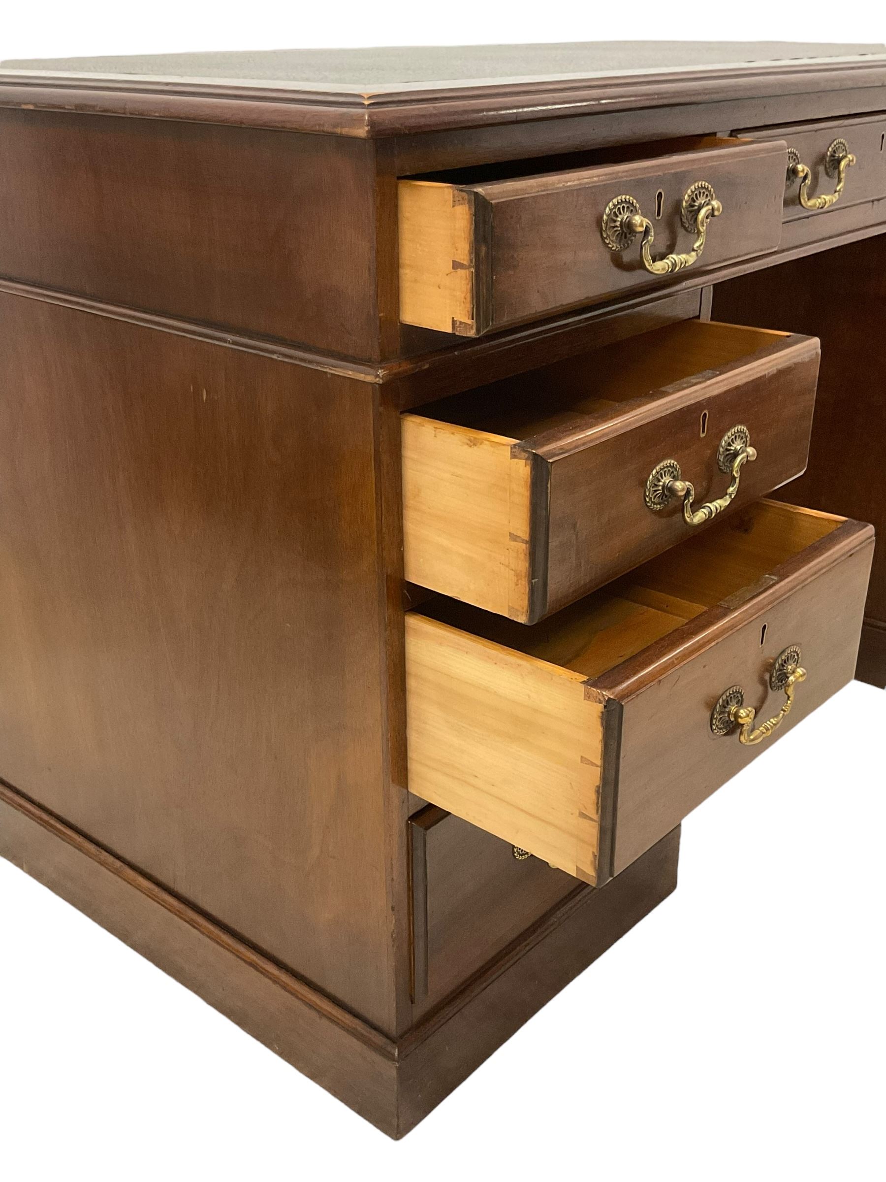 Late 19th century mahogany twin pedestal desk, moulded rectangular top with inset leather, fitted with nine drawers, on plinth base