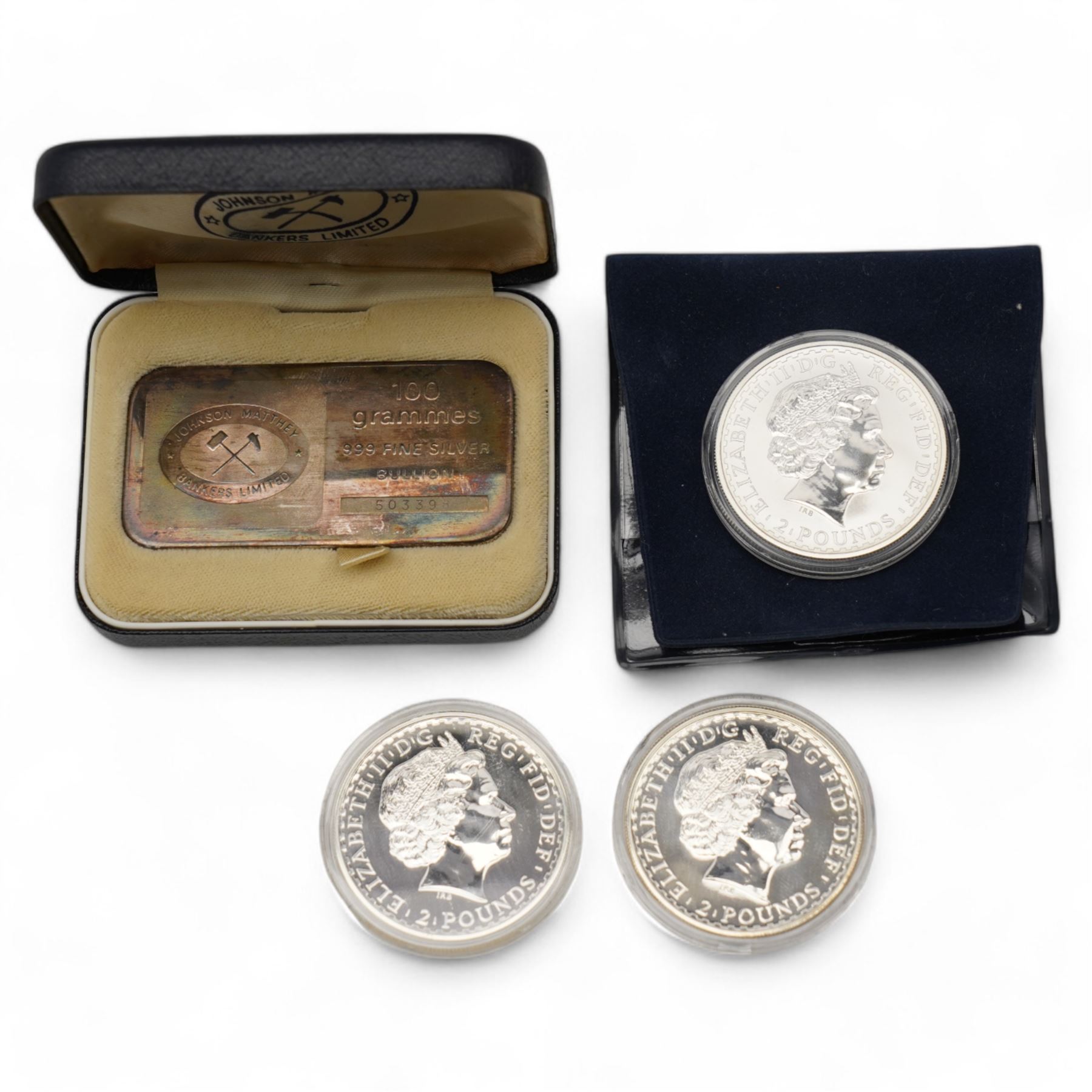 Three Queen Elizabeth II one ounce fine silver Britannia coins, dated 1998, 2008, 2009 and a Johnson Matthey Bankers Limited one-hundred grams fine silver bullion bar, cased 