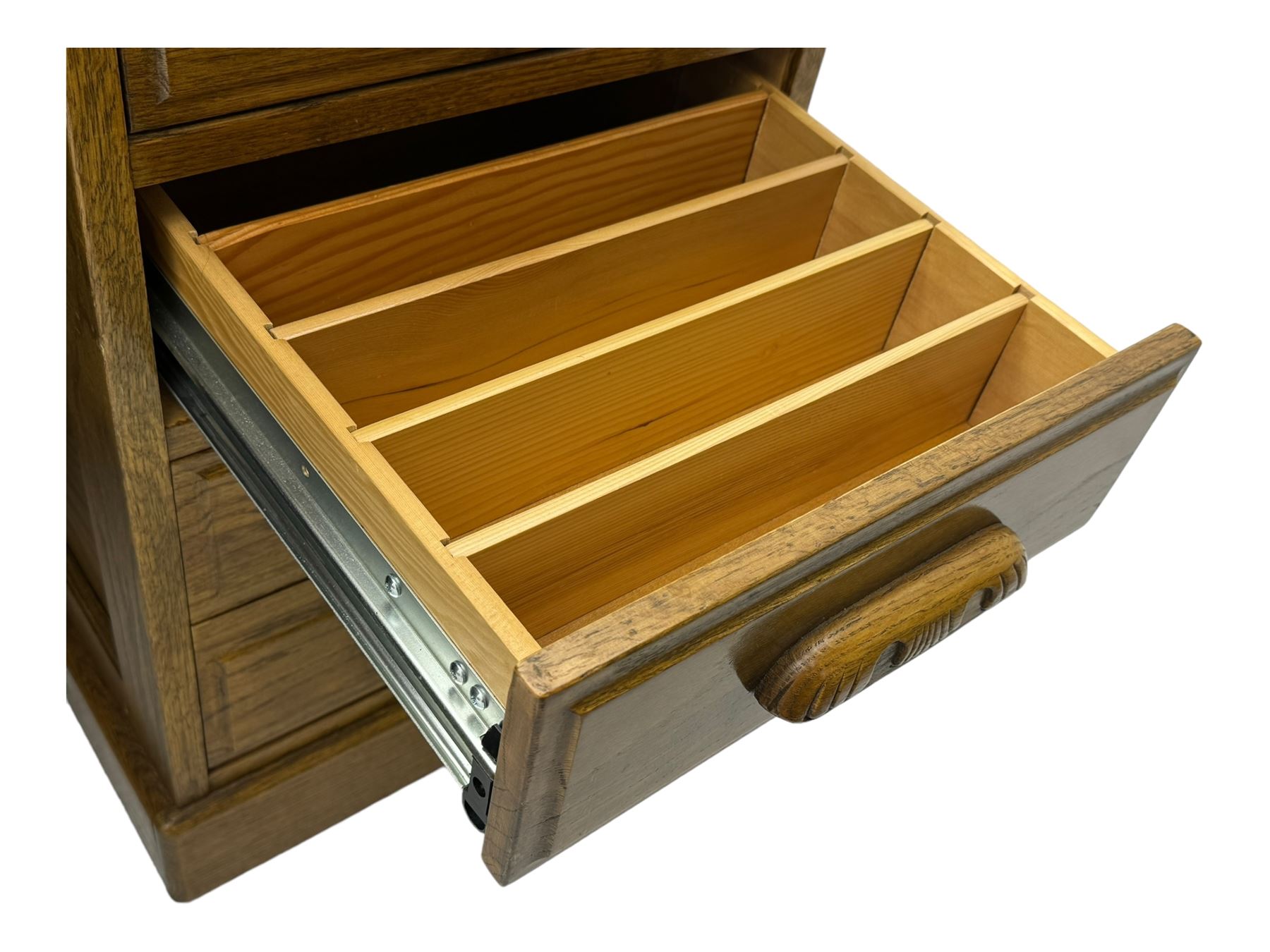 Early 20th century oak tambour roll-top desk, the top with fitted interior including drawers, pigeonholes and compartments, the twin pedestals fitted with four drawers with carved handles, supported by plinth base 