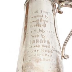 'Tennent Trophy presented by Tennent Caledonian Breweries, Scotland, Ayr 21st July 1975, won by Dakota owned and bred by Mr Guy Reed, trained by Sam Hall, ridden by A Barclay' - A tall lidded tankard with scroll thumbpiece and handle, on a wooden plinth H35cm overall London 1975 Maker Garrard & Co. Ltd