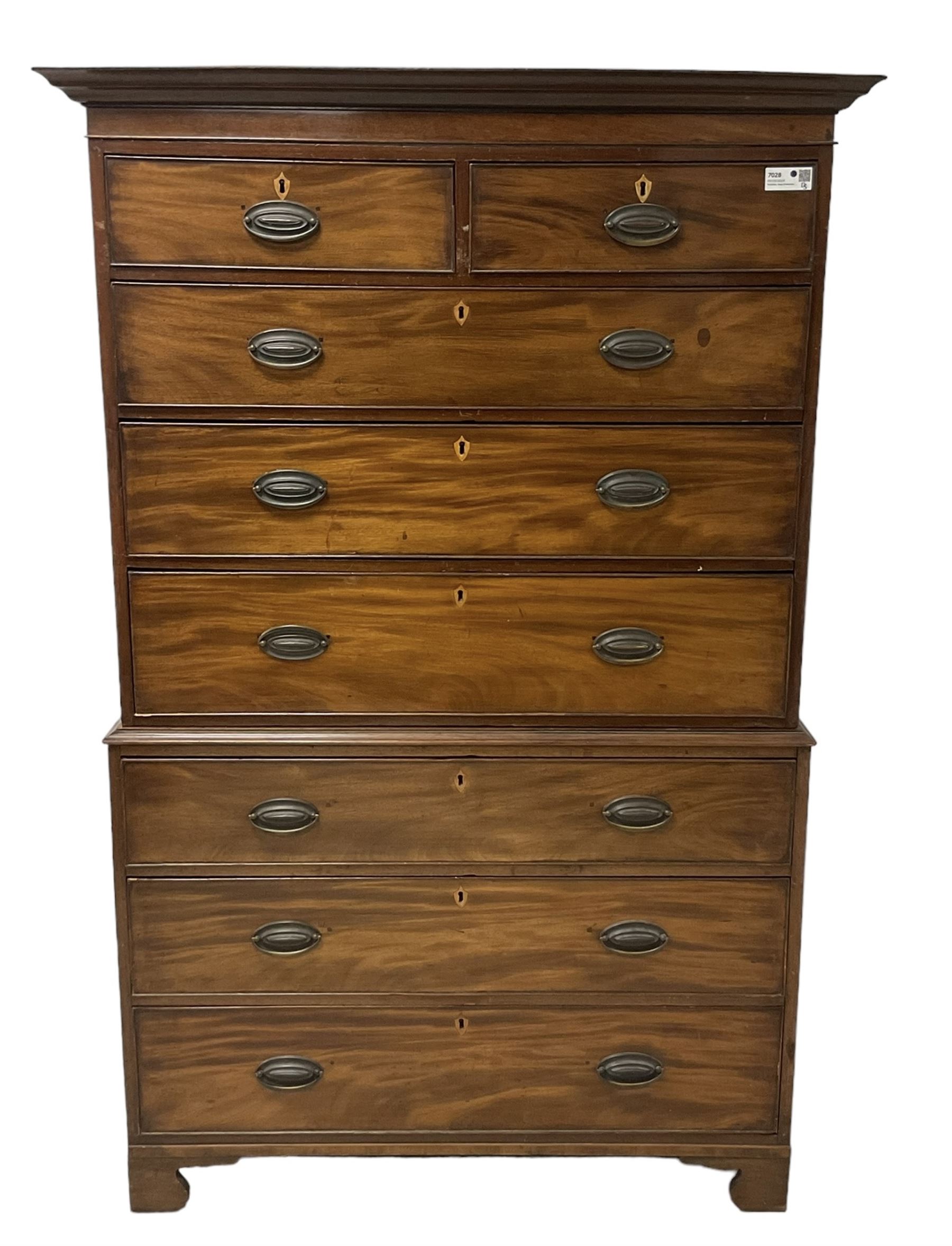 Early 19th century mahogany chest-on-chest, projecting cornice over banded frieze, fitted with two short over six long graduating cock-beaded drawers with bone and timber escutcheons, on bracket feet