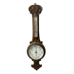 Edwardian - carved oak aneroid barometer, with a rounded top carved with scroll work, 8