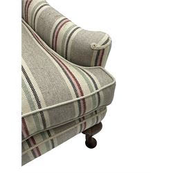 Georgian design hardwood-framed wingback armchair, curved wingback terminating to curved and rolled arms, upholstered in striped fabric with loose seat cushion, on cabriole front feet 