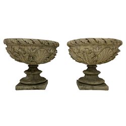 Pair of composite stone garden urn planters, acanthus leaf garland rim over foliate decorated body, stepped foot on square base