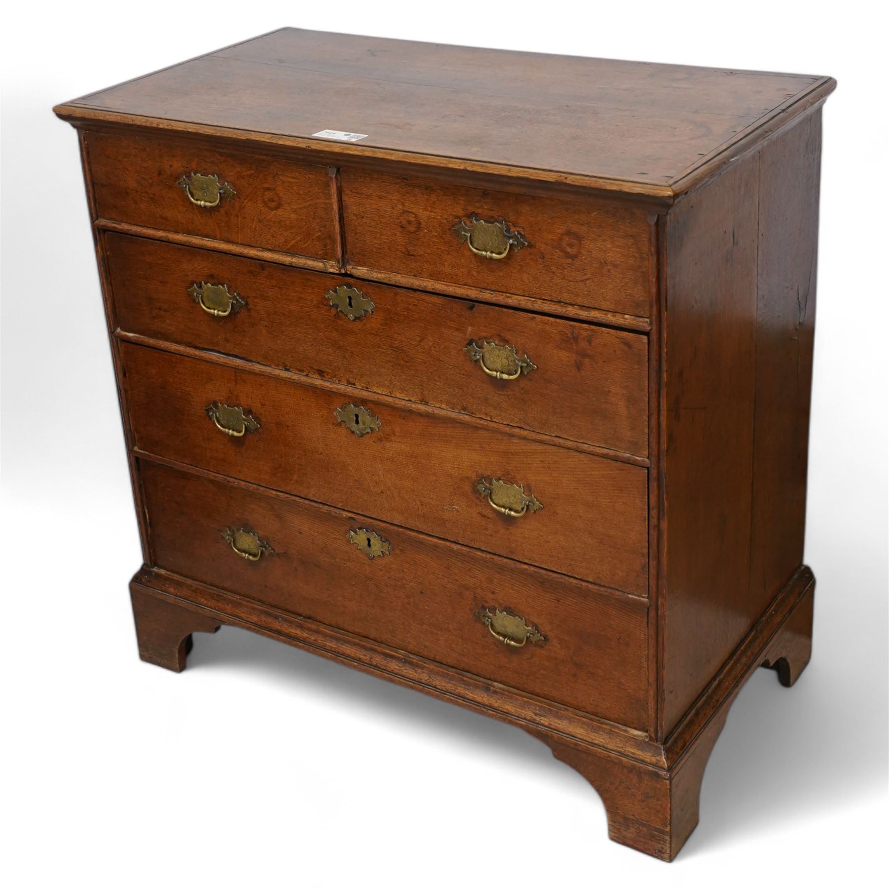 George III oak chest, moulded rectangular top over two short and three long drawers, shaped handles plates with engraved decoration, on bracket feet