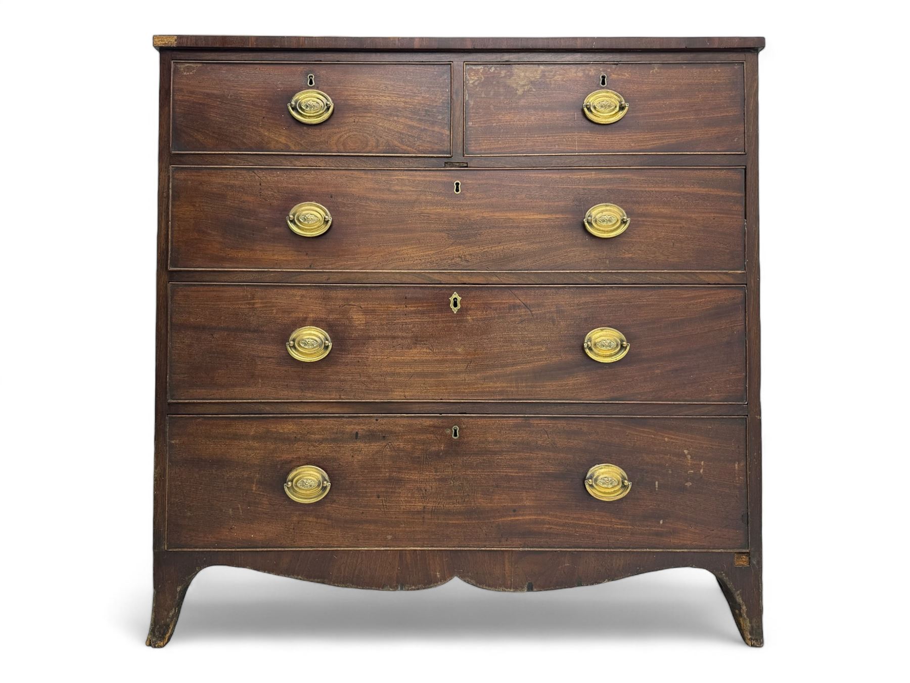 George III mahogany chest, rectangular cross banded top above two short and three long graduating cockbeaded drawers, shaped apron with splayed bracket feet