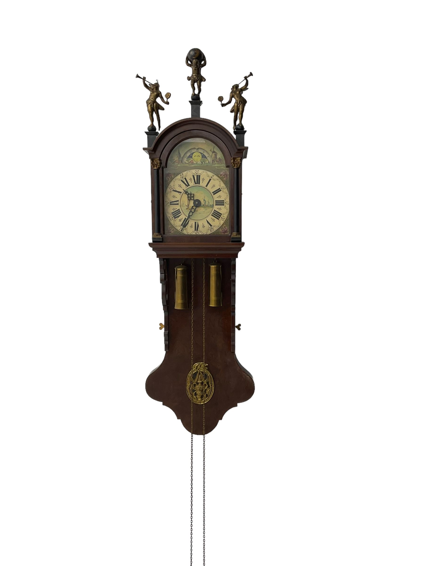 20th century weight driven Dutch WUBA wall clock -  with a break arch top and mounted gilt figures to the arch, painted dial with working moon disc, chapter ring with Roman numerals and pierced steel hands, twin train chain driven movement striking the hours on a bell. With pendulum and brass cased weights.