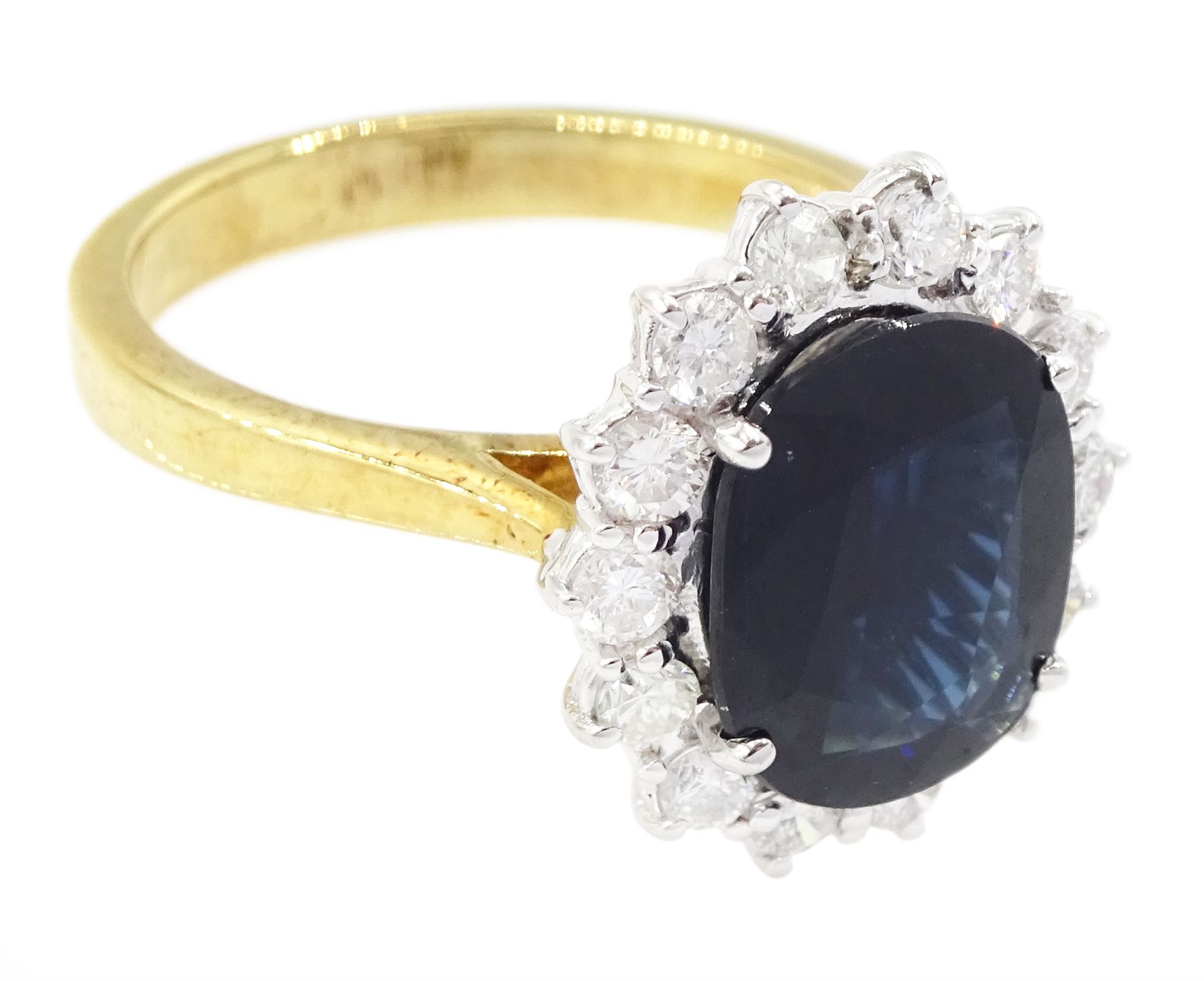 18ct gold oval cut sapphire and round brilliant cut diamond cluster ring, 