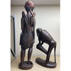 Two African carved hardwood figures, the first carved as a monkey, H43cm, the second as a male figure, H70cm