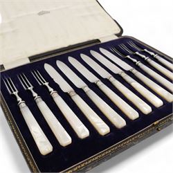 Early 20th century cased set of six fruit knives and forks, with mother of pearl handles and silver collars, by John Sanderson & Son Ltd, Sheffield, 1921, together with a set of six knives (2)