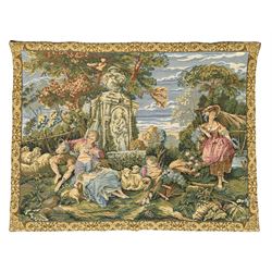 French machine woven tapestry, the scene depicting pastoral life with shepherds and sheep against a backdrop of lush foliage and classical architecture, bordered by a floral and scroll design