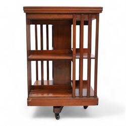 Edwardian mahogany revolving bookcase, square form with moulded top, two tiers with vertical moulded slats, on brass and ceramic castors 