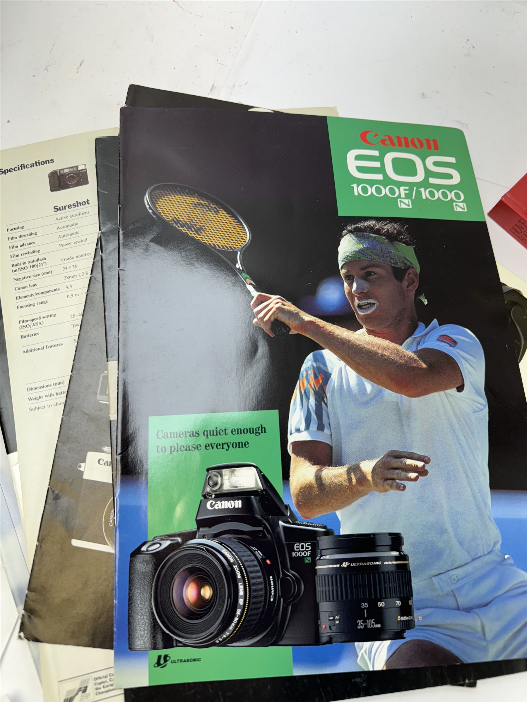 Large collection of Canon camera reference books, brochures, user's guides and instruction manuals, including Canon Compendium by Bob Shell, copies of Lens Wonderland, EOS camera guides, etc 