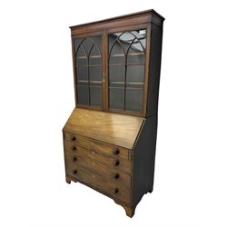 Early 19th century mahogany bureau bookcase, the projecting cornice over two Gothic-style astragal glazed doors enclosing two adjustable shelves, sloped hinged lid enclosing fitted interior and felt inset, four graduating drawers, on bracket feet