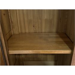 Large 20th century oak dresser, projecting cornice over open arched central section with two shelves, flanked by two panelled cupboards with two shelves, lower section with three drawers above three cupboards, on stile supports 