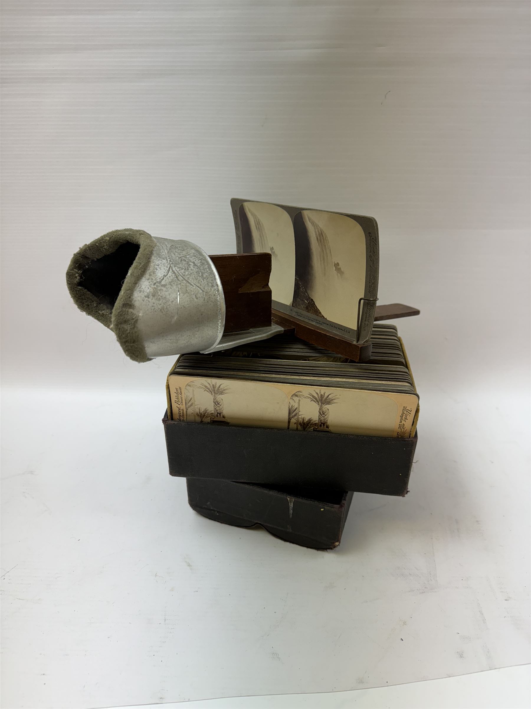 Underwood & Underwood sun sculpture stereoscope viewer, together a box of stereoscopic views, in faux book case