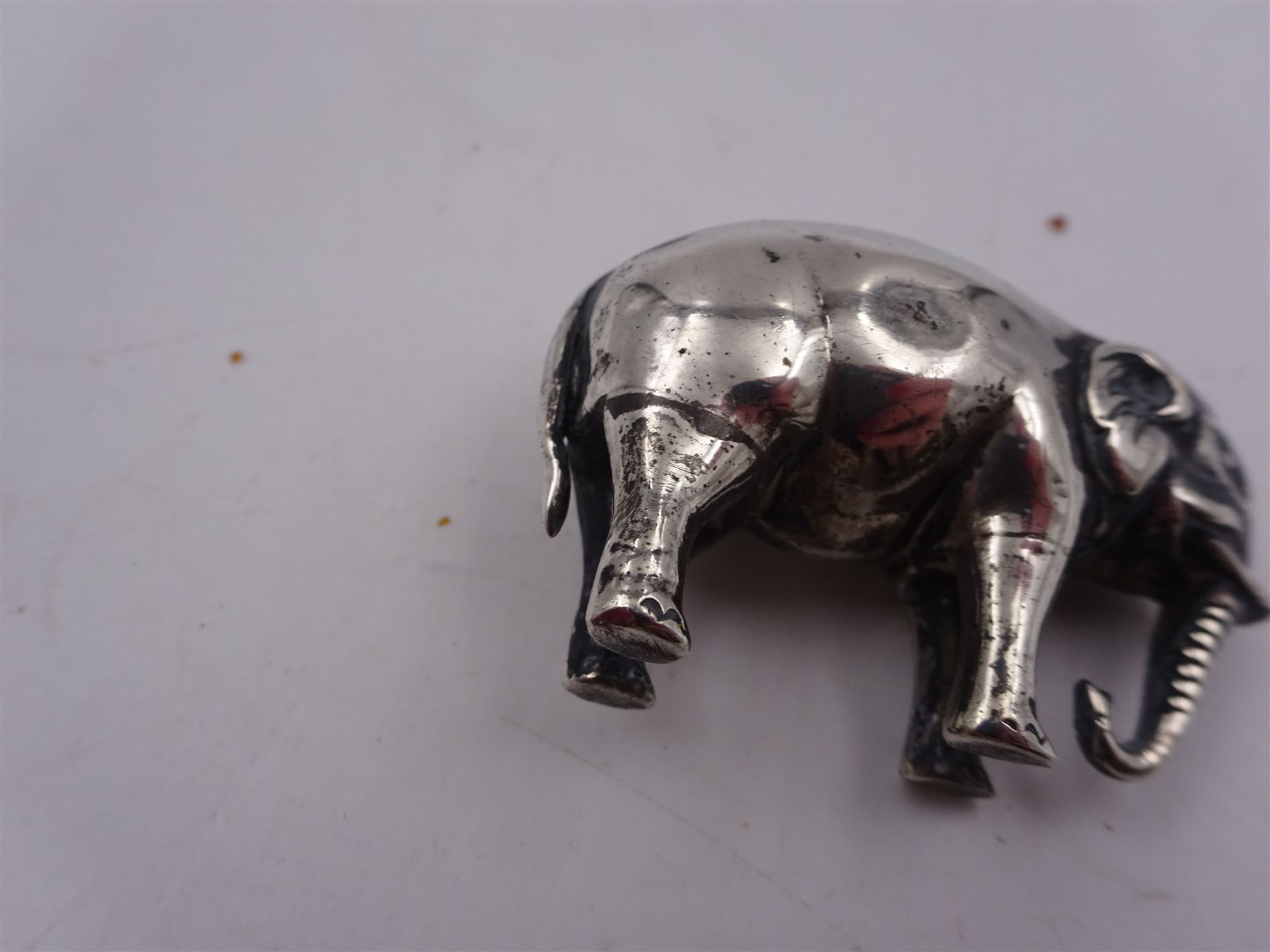 Edwardian silver mounted novelty pin cushion, in the form of an elephant, with cushioned back, hallmarked Birmingham 1906, maker's mark worn and indistinct, L4cm, H3.5cm