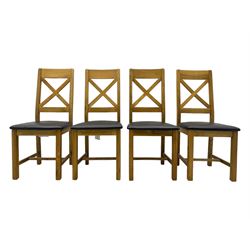 Oak extending dining table, square pull-out action top with folding butterfly leaf, on straight square supports; set of four dining chairs, X-shaped backrest and black upholstered seat, on square supports united by H-stretcher