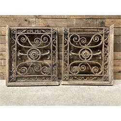 Pair of heavy ornate cast iron balustrades, square form with timber brackets