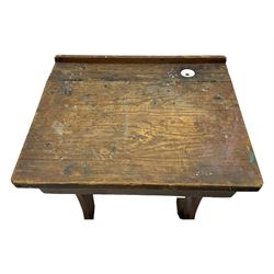 Three pitch pine school desks, each with rectangular lift-top with recessed ink well enclosing storage compartment, on trestle supports joined by stretcher