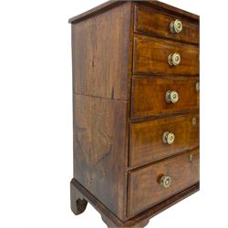 George I walnut chest, moulded rectangular top with book-matched veneers within crossbanding, fitted with two short over four long graduating drawers, moulded drawer fronts with brass handles, on bracket feet, the chest will split into two sections 