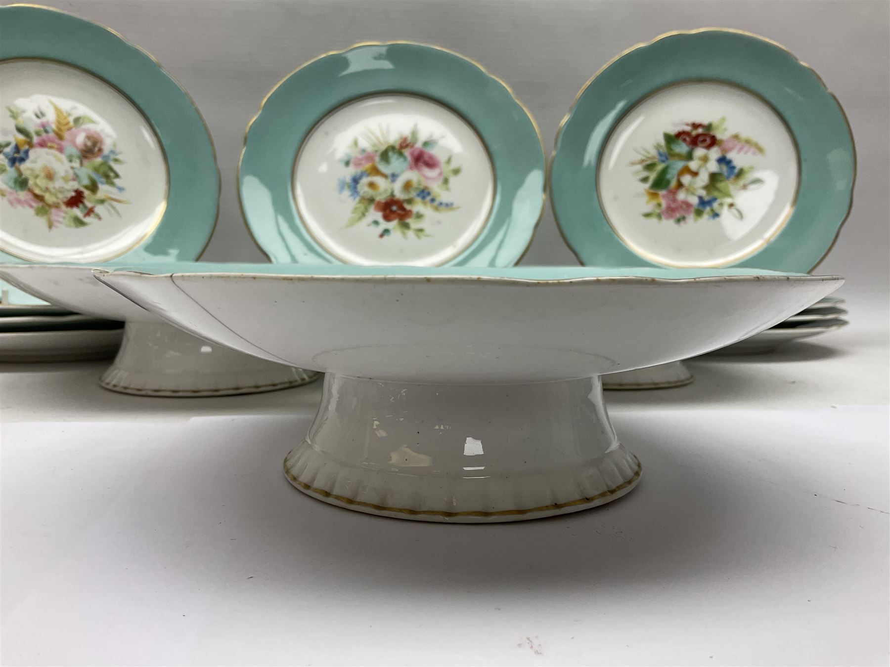 Victorian dessert service, comprising three comports and twelve plates, each decorated with floral sprigs to the centre with a blue and gilt border