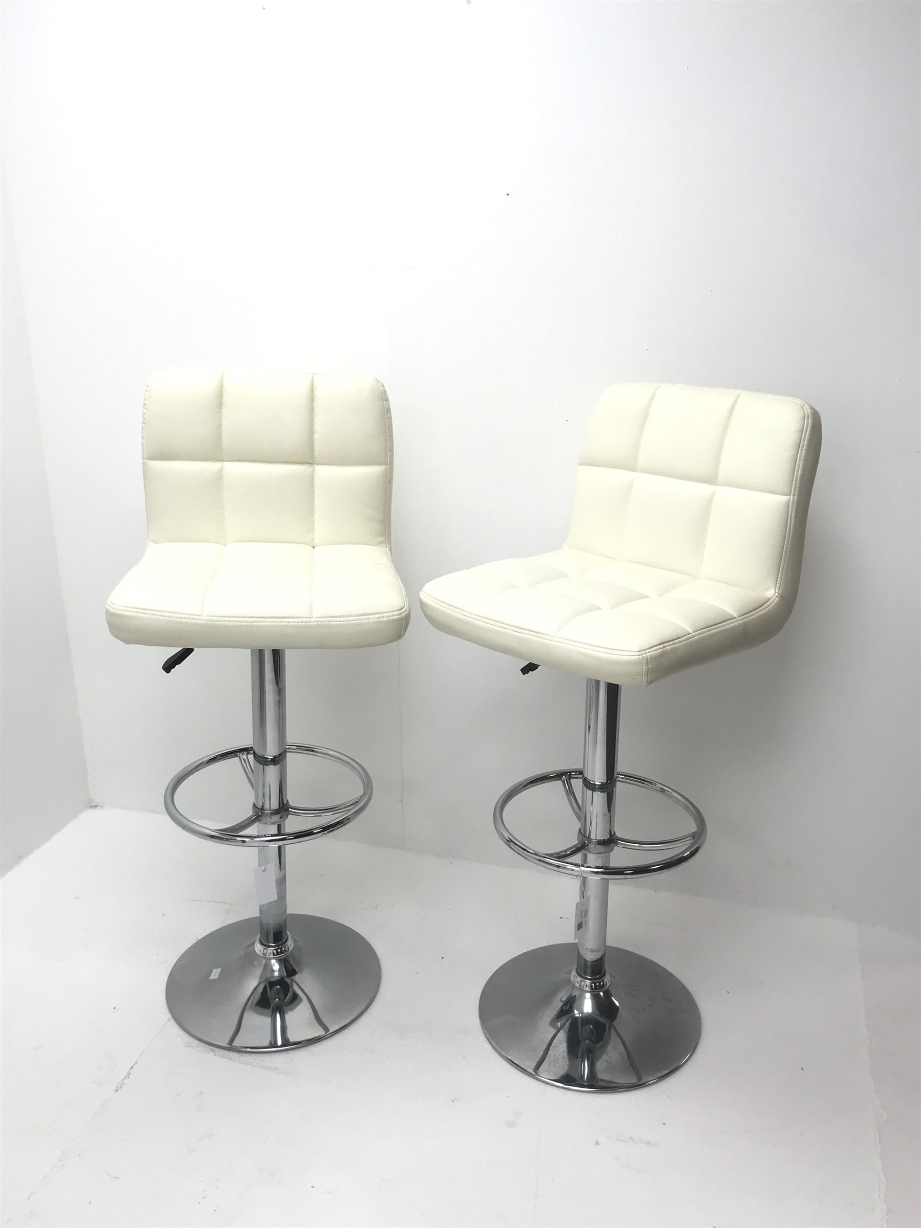 Pair swivel breakfast bar stools upholstered in a white leatherette on chrome base