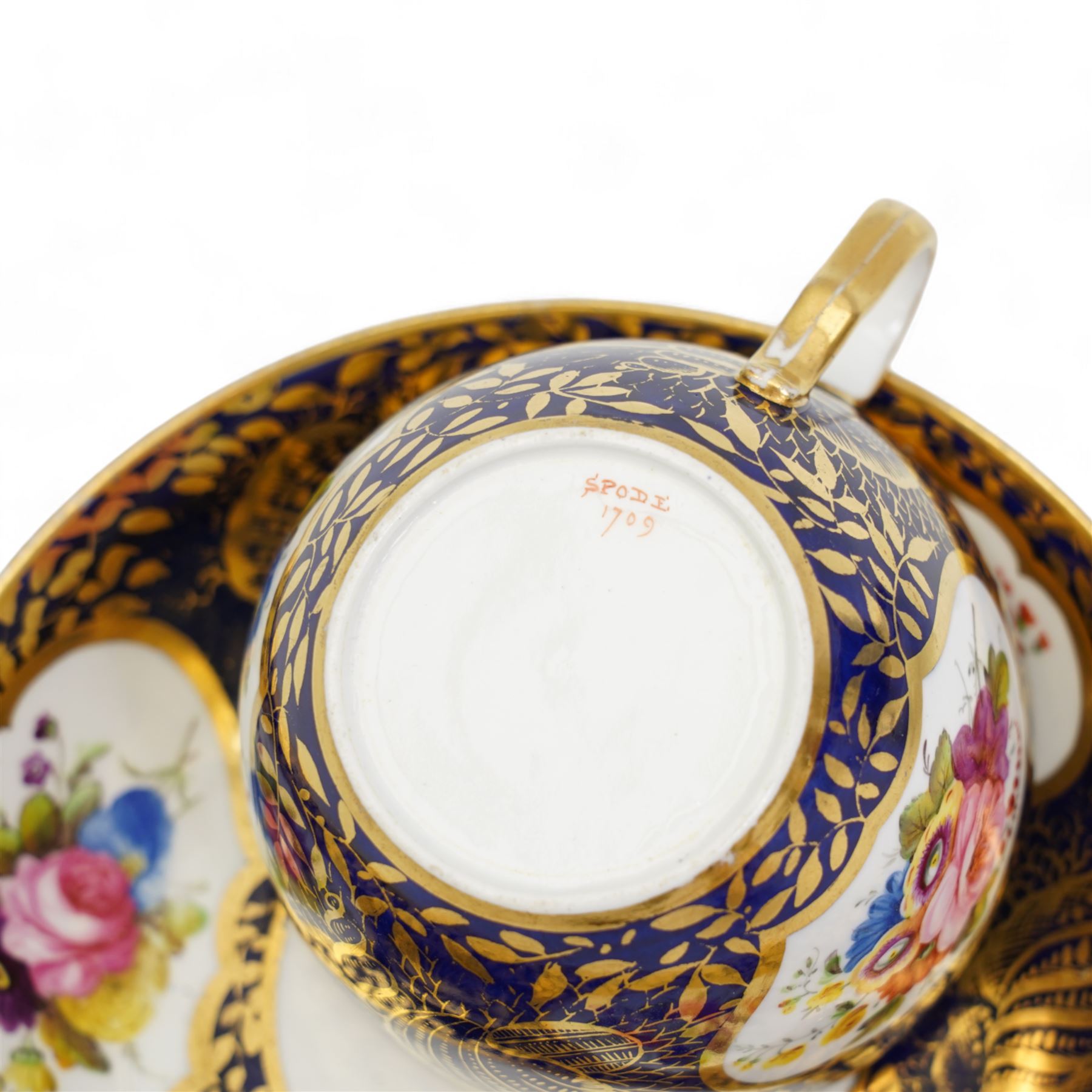 Four early 19th century Spode cups and saucers, two decorated in the Imari palette, pattern no. 2375, and two others, pattern no. 3260 & 1709, together with two early 19th century porcelain rococo revival chambersticks and another Spode tea cup (11)